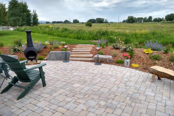 Concrete Paver Patio with Boulders and Gardens and Fireplace Bozeman
