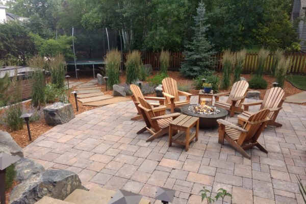 Concrete Paver Patio with Gas Fire Pit and Hot Tub and Boulders in Bozeman Montana