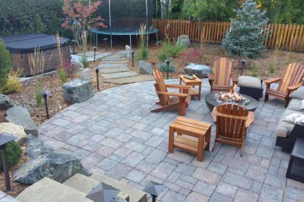 Outdoor Living Space with Gas Fire Pit and Concrete Pavers and Hot Tub and Boulders and Landscape lighting Bozeman Montana
