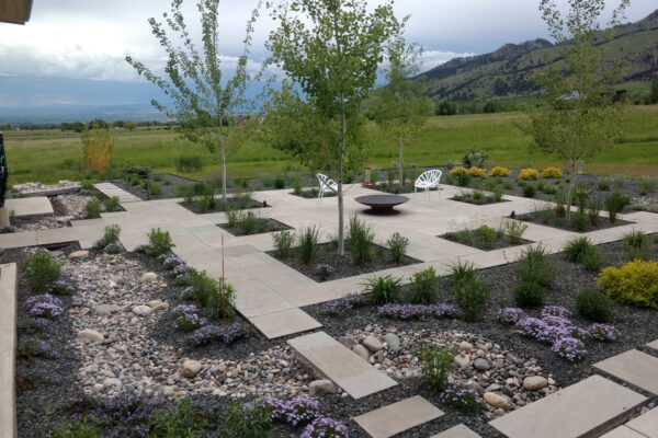 Stone Paver Patio and Dry Creek Bed In Drought Tolerant Gardens