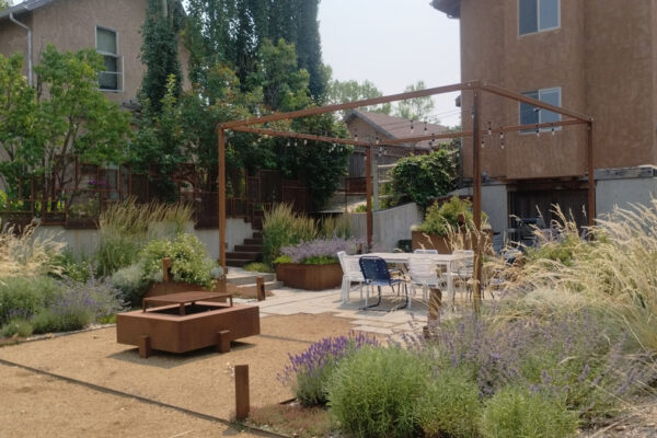 Bozeman Custom Landscaping With Steel Planters and Custom Fire Pit and Custom Landscape Lighting Design